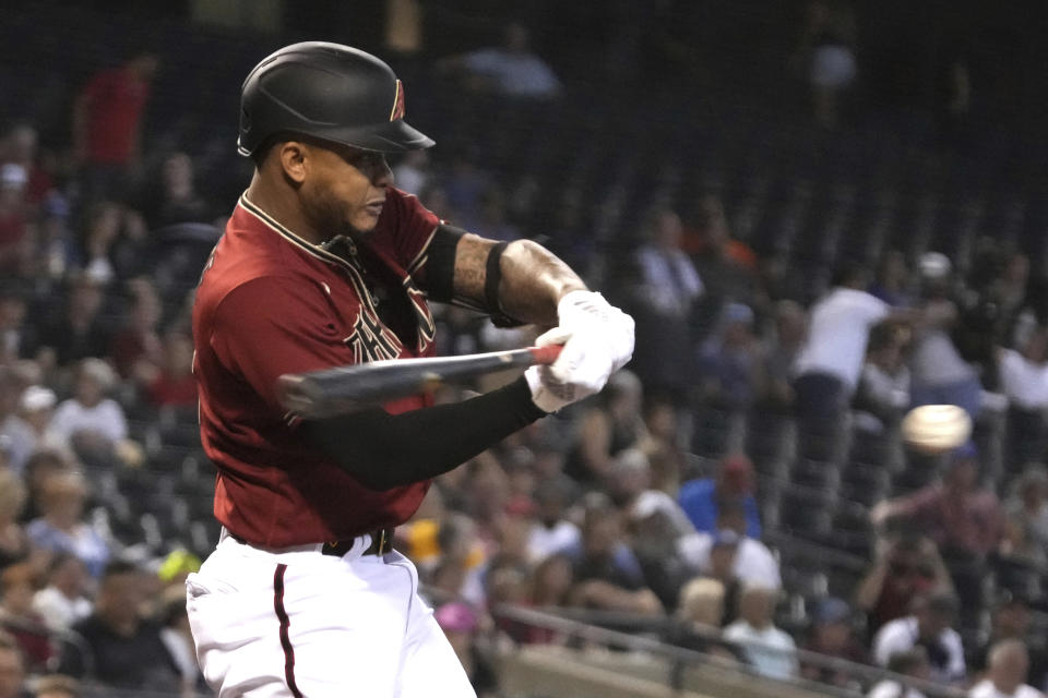 Arizona Diamondbacks' Ketel Marte hits a single against the Los Angeles Angels in the first inning during a baseball game, Sunday, June 13, 2021, in Phoenix. (AP Photo/Rick Scuteri)