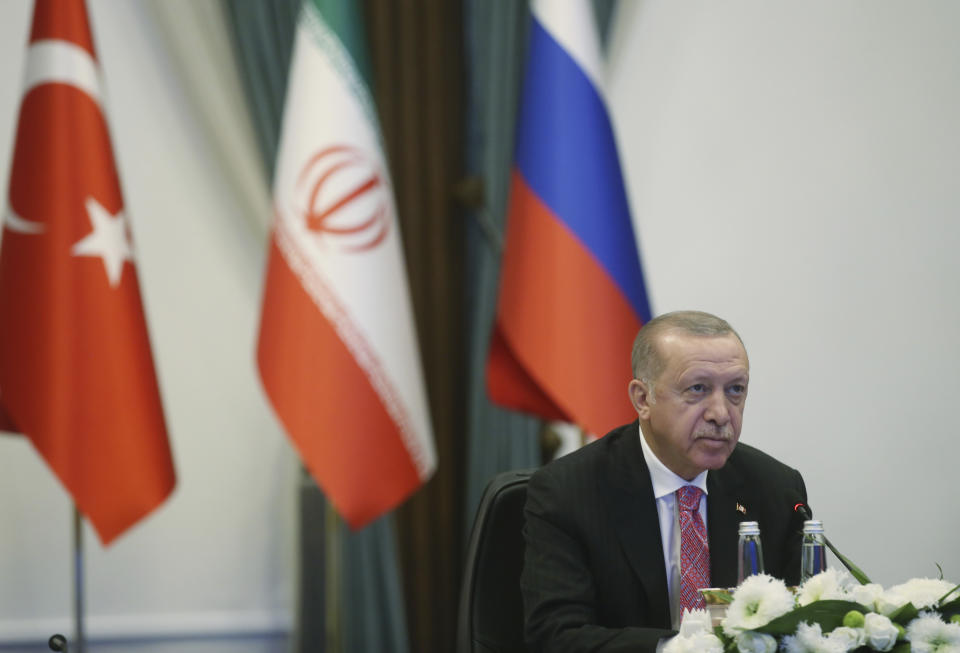 Turkey's President Recep Tayyip Erdogan speaks during a video conference with Russia's President Vladimir Putin and Iran's President Hassan Rouhani, in Ankara, Turkey, Wednesday, July 1, 2020. In his opening remarks to the three-way summit between the Turkish, Iranian and Russian leaders, Erdogan said the three countries' aim was to protect Syria's political and territorial unity, to end the fighting on the ground and to find a political solution to the conflict.(Presidential Press Service via AP, Pool)