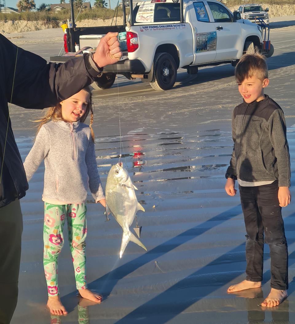 Roy Mattson thrills a couple of youngsters with a fresh-caught pompano.