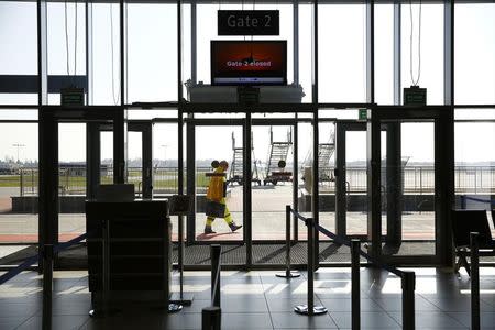 An employee walks at the airport in Lodz October 10, 2014. REUTERS/Kacper Pempel