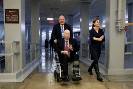 FILE PHOTO: Sen. John McCain heads to the Senate floor on Capitol Hill in Washington, U.S., December 6, 2017. REUTERS/Aaron P. Bernstein