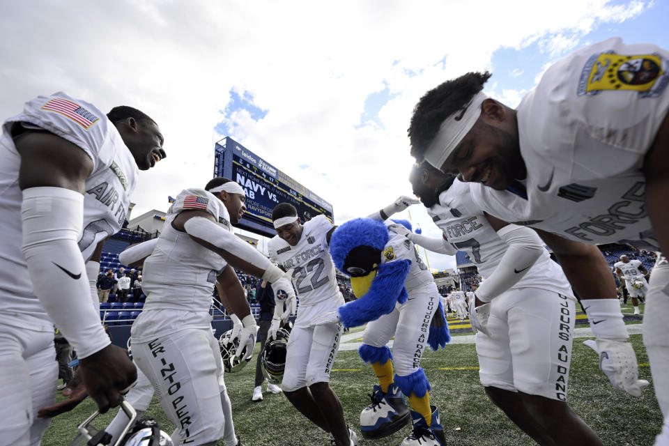 Air Force players and mascot dance on the sideline after defeating Navy in an NCAA college football game, Saturday, Oct. 21, 2023, in Annapolis. (AP Photo/Terrance Williams)