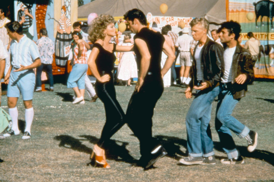 Danny and Sandy from Grease in a dance pose at the carnival