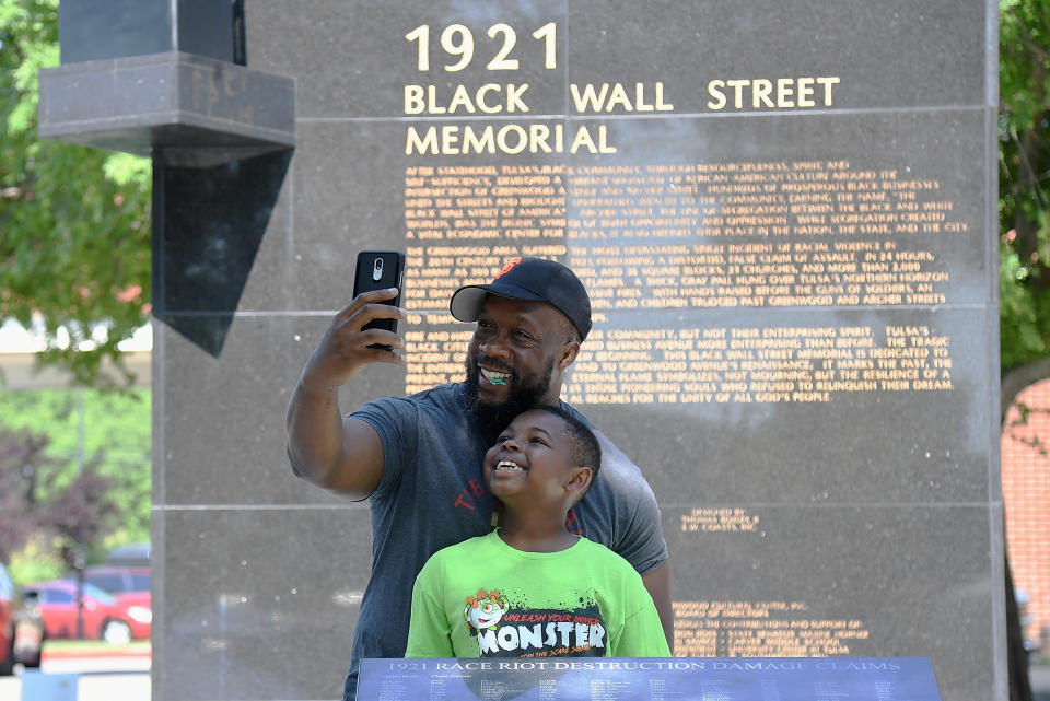 A father and son take a selfie at the Black Wall Street Memorial (Michael B. Thomas / Getty Images)