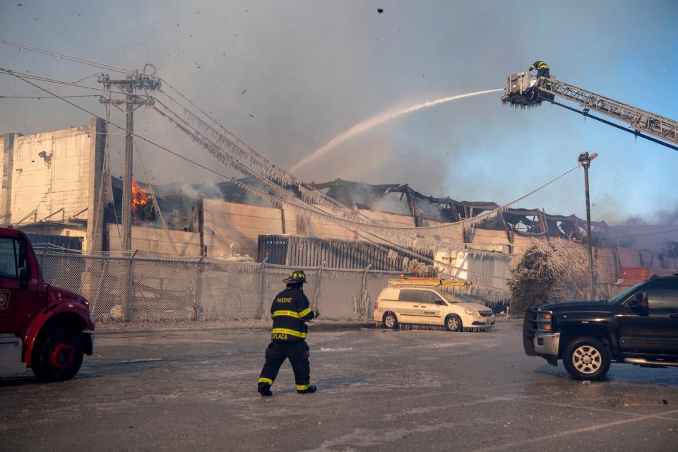 Firefighters battling a fire at Atlantic Coast Fibers recycling plant at 101 7th St. in Passaic on Saturday, Jan. 30, 2021.