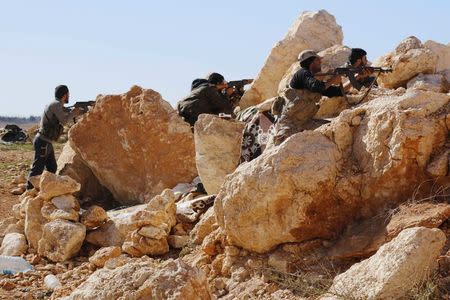 Rebel fighters take up positions on the frontline against forces of Syria's President Bashar al-Assad in the Handarat area, north of Aleppo October 20, 2014. REUTERS/Hosam Katan