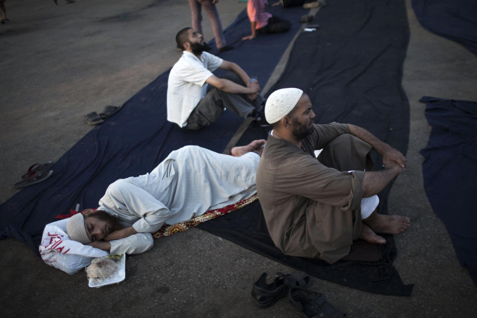 Supporters of Egypt's ousted President Mohammed Morsi rest before breaking their fast during a protest near Cairo University in Giza, Egypt, Thursday, August, 1, 2013. (AP Photo/Manu Brabo)