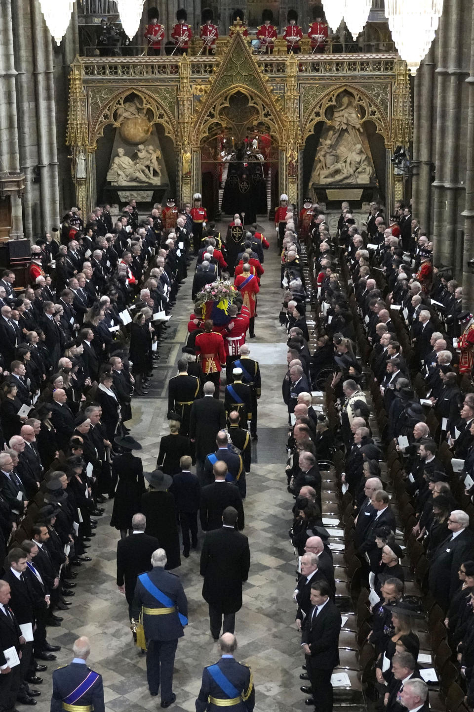 Britain's King Charles III, Camilla, the Queen Consort, Princess Anne, and her husband Vice Admiral Tim Laurence, Prince Andrew, Prince Edward, and his wife Sophie, Countess of Wessex, Prince William, and Kate, Princess of Wales with their children Princess Charlotte of Wales, Prince George of Wales, Britain's Prince Harry, and his wife Meghan, the Duchess of Sussex, David Armstrong-Jones, Earl of Snowden, Peter Phillips, The Duke of Gloucester, Prince Michael of Kent and the Duke of Kent follow the coffin of Queen Elizabeth II is carried into Westminster Abbey for her funeral in central London, Monday, Sept. 19, 2022. The Queen, who died aged 96 on Sept. 8, will be buried at Windsor alongside her late husband, Prince Philip, who died last year. (AP Photo/Frank Augstein, Pool)