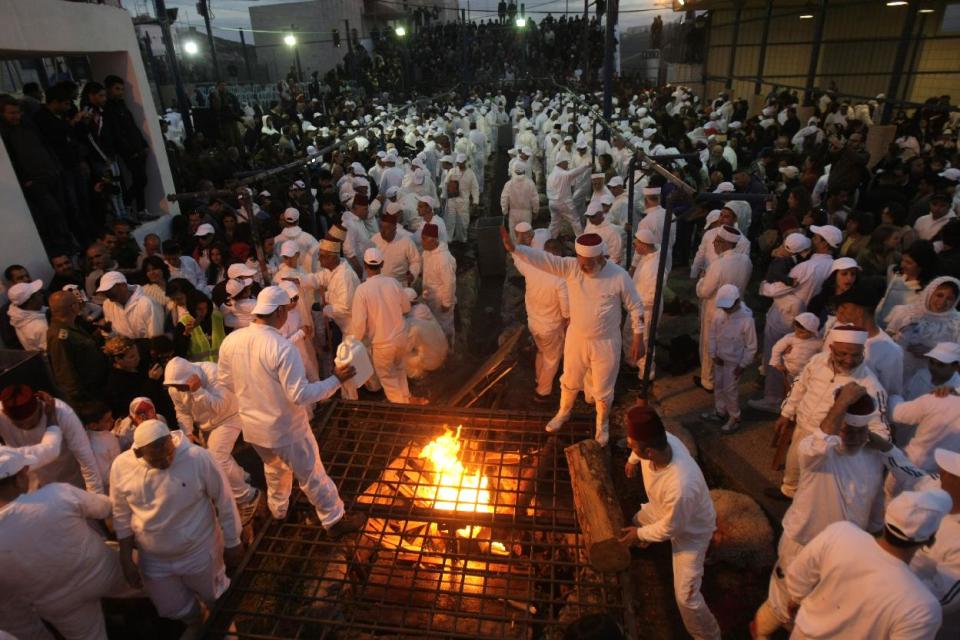 Members of the ancient Samaritan community participate in the ritual of Passover Sacrifice on Mount Grizim, overlooking the West Bank town of Nablus, Sunday, April 13, 2014. Samaritans descended from the ancient Israelite tribes of Menashe and Efraim but broke away from mainstream Judaism 2,800 years ago. Today, the remaining 700 Samaritans live in the Palestinian city of Nablus in the West Bank and the Israeli seaside town of Holon, south of Tel Aviv. (AP Photo/Nasser Ishtayeh)