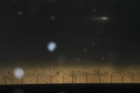 Snow begins to fall in front of wind turbines near the village of Jaywick in Britain January 13, 2017. REUTERS/Stefan Wermuth