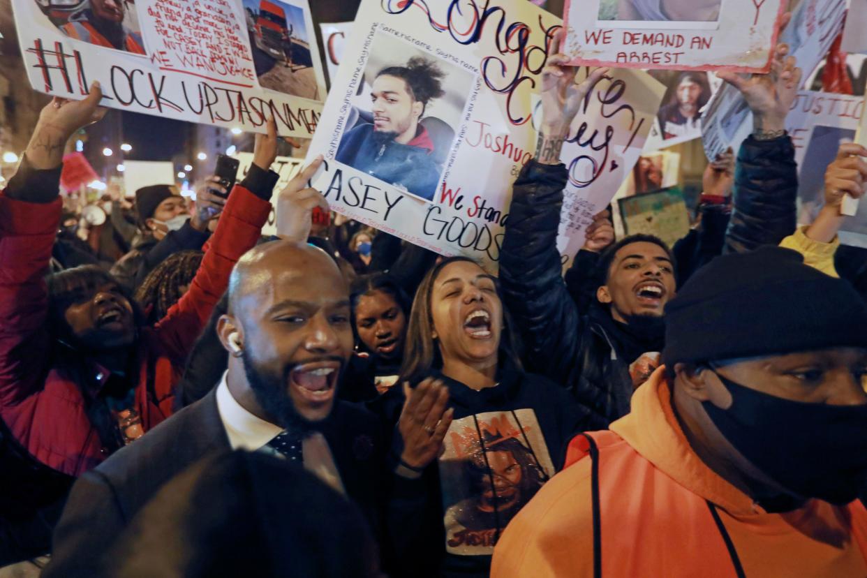 Tamala Payne, center, with attorney Sean Walton, participate during a protest march for the shooting of her son, Casey Goodson Jr.