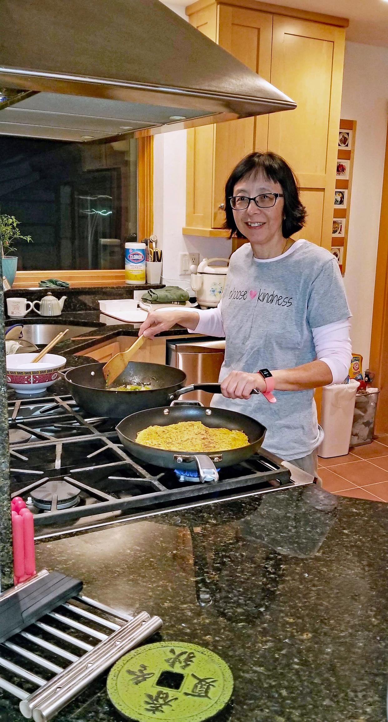 While her dad cooked on a traditional stainless steel wok, Mabel prefers nonstick for ease. Here, she makes Cantonese chow mein.