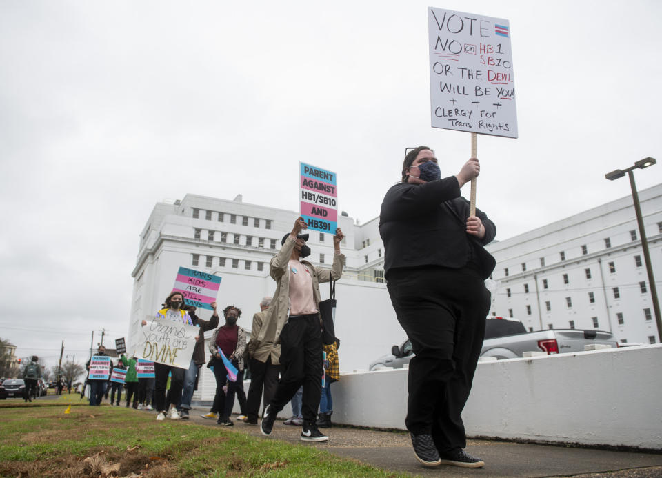 FILE - In this Tuesday, March 2, 2021 file photo, protestors in support of transgender rights march around the Alabama State House in Montgomery, Ala. Pride Month celebrations in the U.S. are taking place under unusual circumstances in June 2021, with pandemic-related concerns disrupting many of the usual festivities and political setbacks dampening the mood of LGBTQ-rights activists. (Jake Crandall//The Montgomery Advertiser via AP, File)=ALMON