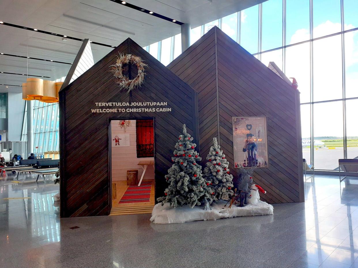 A cabin is shown inside of the Helsinki aiport decorated in Christmas themes.