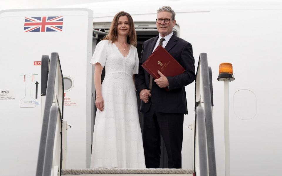 Lady Starmer opted for a simple white knitted dress for her flight to Washington DC on Tuesday