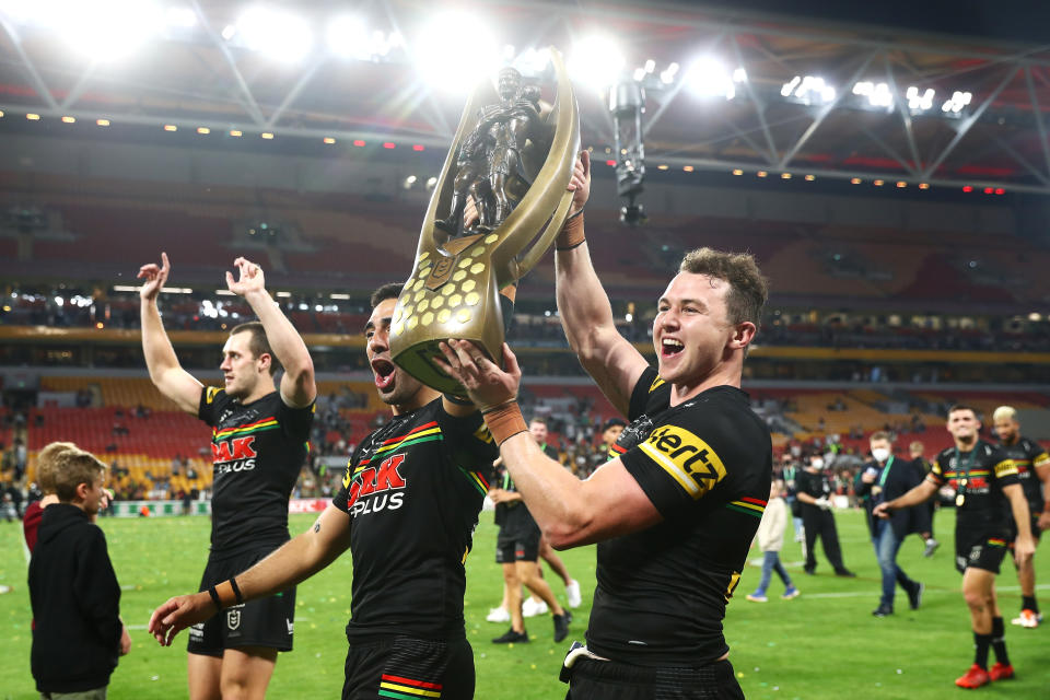 BRISBANE, AUSTRALIA - OCTOBER 03:  Tyrone May and Dylan Edwards of the Panthers celebrate with the NRL Premiership Trophy after victory in  the 2021 NRL Grand Final match between the Penrith Panthers and the South Sydney Rabbitohs at Suncorp Stadium on October 03, 2021, in Brisbane, Australia. (Photo by Chris Hyde/Getty Images)