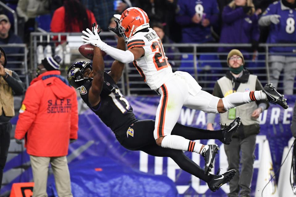 Baltimore Ravens wide receiver Devin Duvernay (13) has the pass broken up by Cleveland Browns cornerback Denzel Ward (21) during the second quarter of an NFL football game, Sunday, Nov. 28, 2021, in Baltimore. (AP Photo/Terrance Williams)