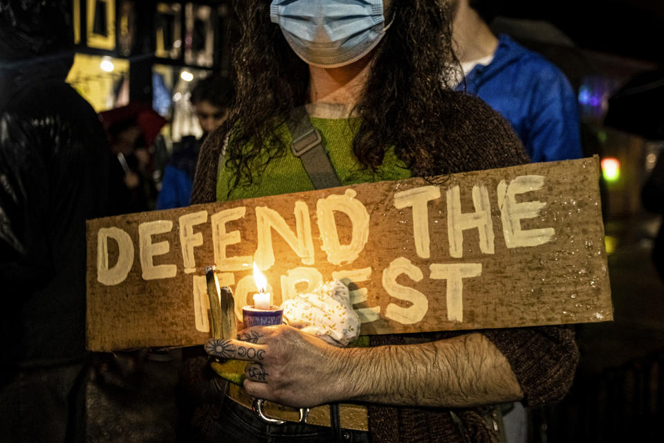 A protester holds up a sign that says 