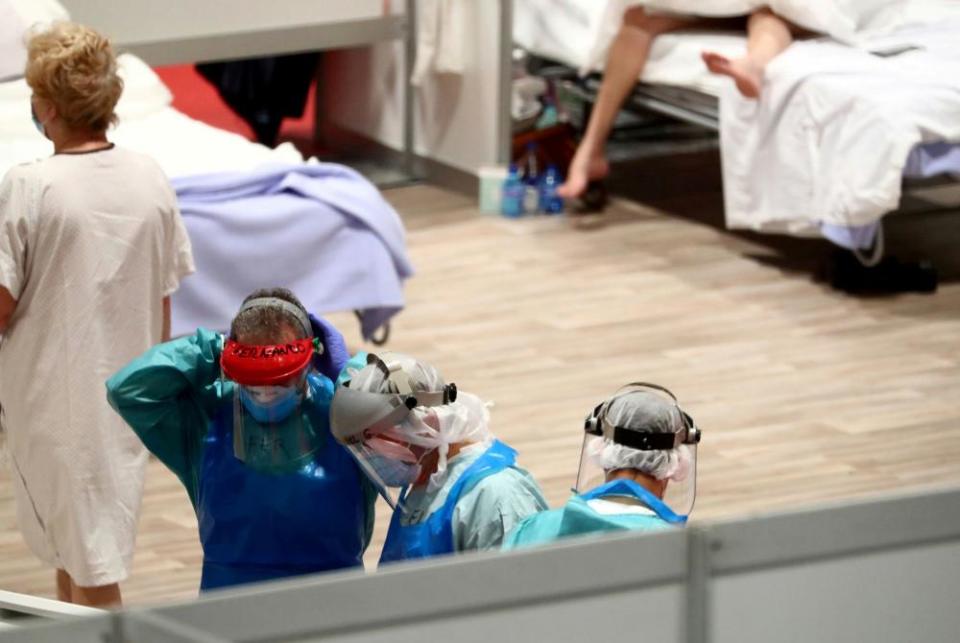 Medical staff work at a temporary hospital inside the Ifema conference centre, amid the coronavirus disease in Madrid, Spain.