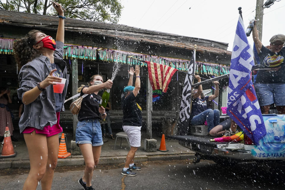 People celebrate outside Vaughn's Lounge in the Bywater section of New Orleans, Saturday, Nov. 7, 2020, after news outlets called the Presidential election in favor of President-elect Joe Biden and his running mate, Vice President-elect Kamala Harris. (AP Photo/Gerald Herbert)