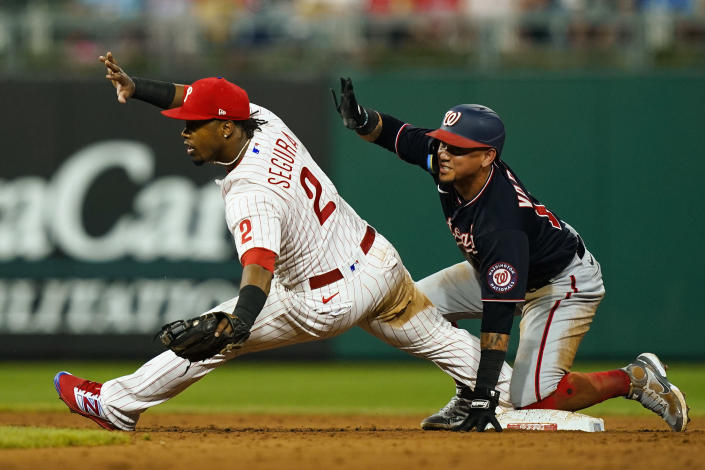 Washington Nationals' Ildemaro Vargas, right, slides safely into second past Philadelphia Phillies' Jean Segura on a single by Victor Robles during the sixth inning of a baseball game, Saturday, Aug. 6, 2022, in Philadelphia. (AP Photo/Matt Rourke)