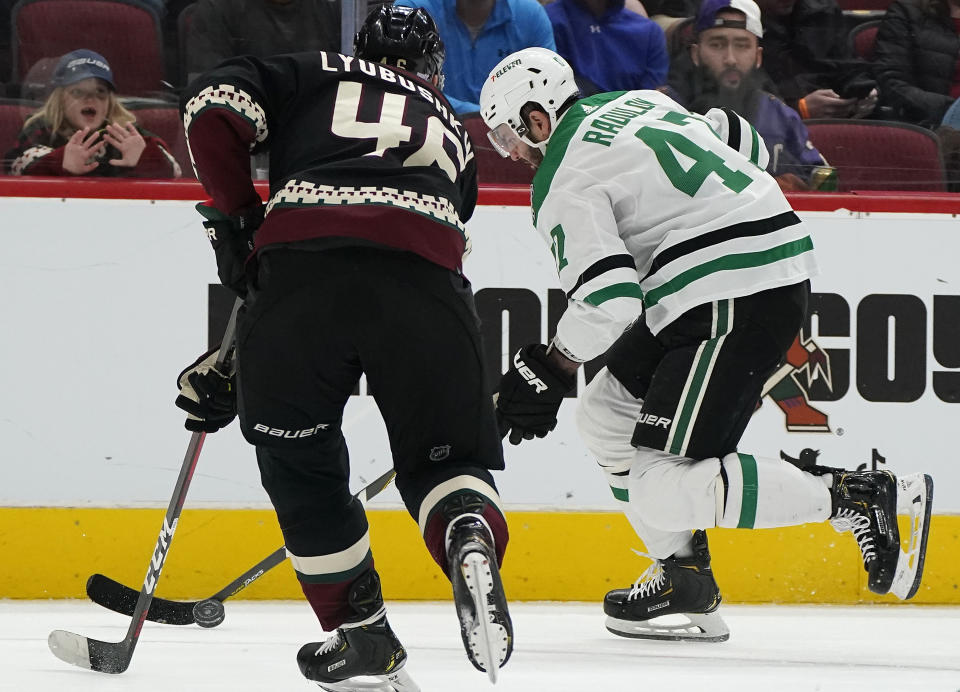 Dallas Stars Alexander Radulov (47) controls the puck against Arizona Coyotes Ilya Lyubushkin (46) during the second period of an NHL hockey game Saturday, Nov. 27, 2021, in Glendale, Ariz. (AP Photo/Darryl Webb)