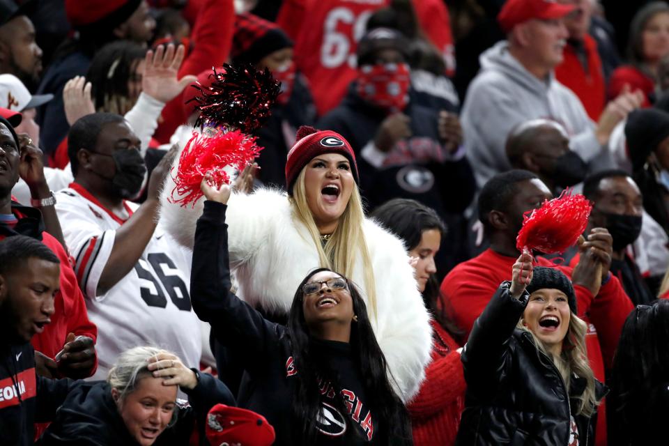 Georgia Bulldogs fans cheer Monday, Jan. 10, 2022, during the College Football Playoff National Championship at Lucas Oil Stadium in Indianapolis.