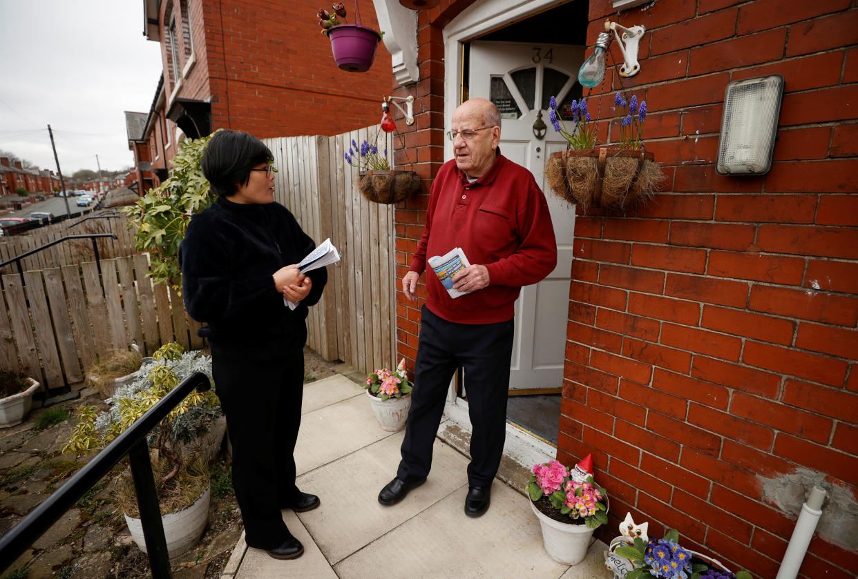 Jihyun Park, who fled North Korea before settling in Britain, talks with a local resident while out delivering leaflets after deciding to stand for election as a Conservative party candidate in the upcoming local elections in the Moorside Ward in Bury, Britain, March 22, 2021. Picture taken March 22, 2021. REUTERS/Phil Noble