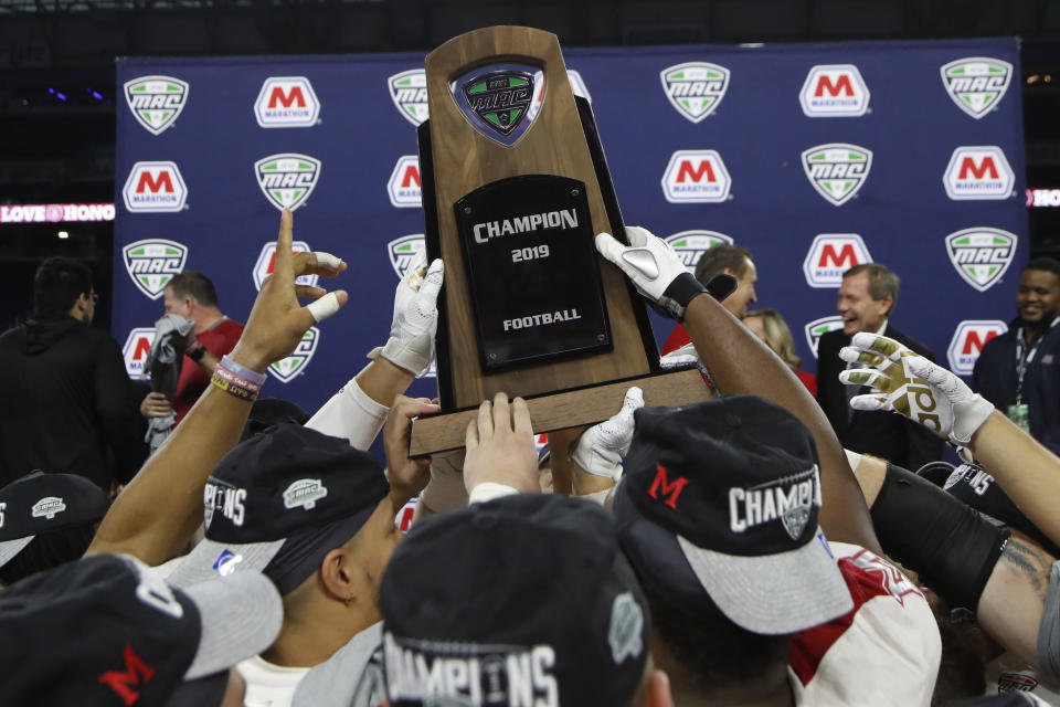 d FILE - In this Dec. 7, 2019, file photo, members of the Miami of Ohio team hold the champion trophy after the Mid-American Conference championship NCAA college football game against Central Michigan in Detroit. The Mid-American Conference announced Friday, Sept. 25, 2020, that it will have a 6-game football season, meaning all 10 major conferences will play this fall. (AP Photo/Carlos Osorio, File)