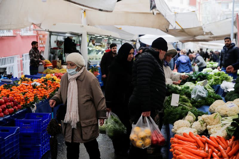 FILE PHOTO: People shop at an open market in Istanbul