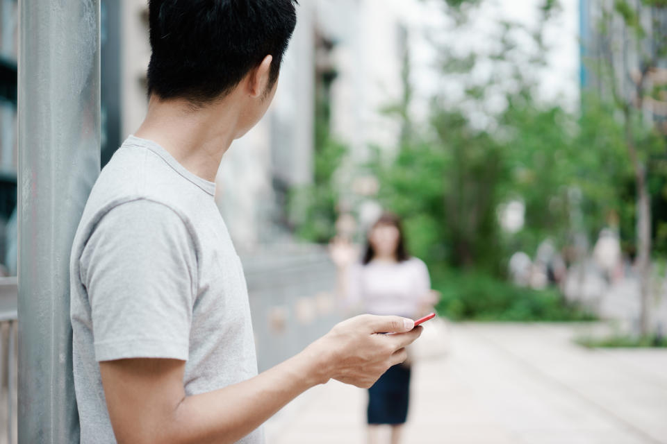 A young Asian couple enjoys a date in the city.