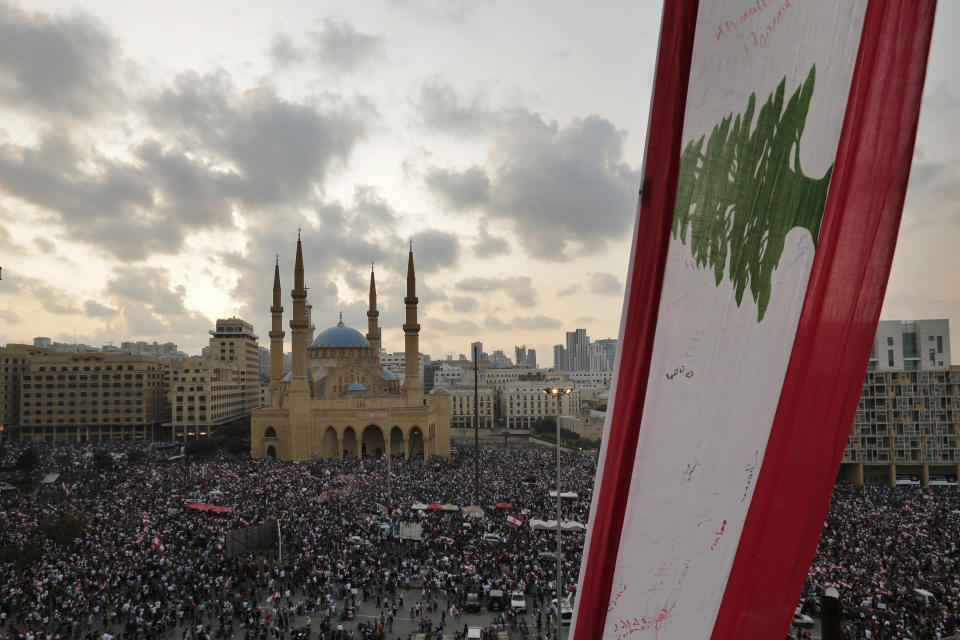 Anti-government protesters shout slogans in Beirut, Lebanon, Sunday, Oct. 20, 2019. Tens of thousands of Lebanese protesters of all ages gathered Sunday in major cities and towns nationwide, with each hour bringing hundreds more people to the streets for the largest anti-government protests yet in four days of demonstrations. (AP Photo/Hassan Ammar)