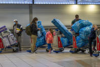 People line up to get on an overseas flight at OR Tambo International Airport in Johannesburg, South Africa, Friday Nov. 26, 2021. A slew of nations moved to stop air travel from southern Africa on Friday in reaction to news of a new, potentially more transmissible COVID-19 variant that has been detected in South Africa. Scientists say it is a concern because of its high number of mutations and rapid spread among young people in Gauteng, the country's most populous province. (AP Photo/Jerome Delay)