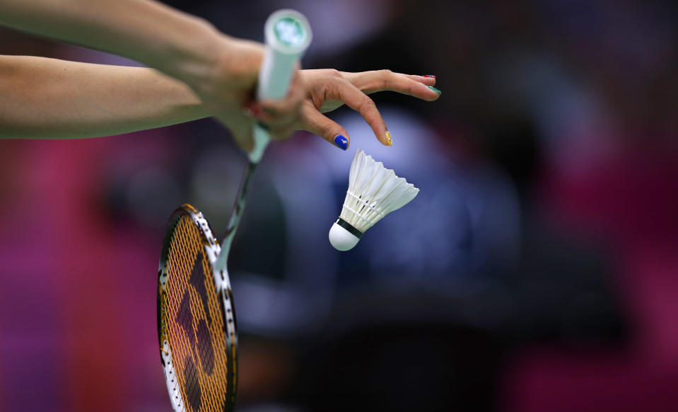 Japan's Reiko Shiota serves during a mixed doubles badminton match of the 2012 Summer Olympics, Saturday, July 28, 2012, in London. (AP Photo/Saurabh Das)