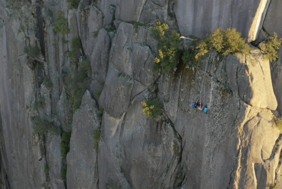 The portaledge is propelled from the top of the cliff. Crew are on hand camping at the top in case help is needed. Source: Airbnb/ Andrew Dawson