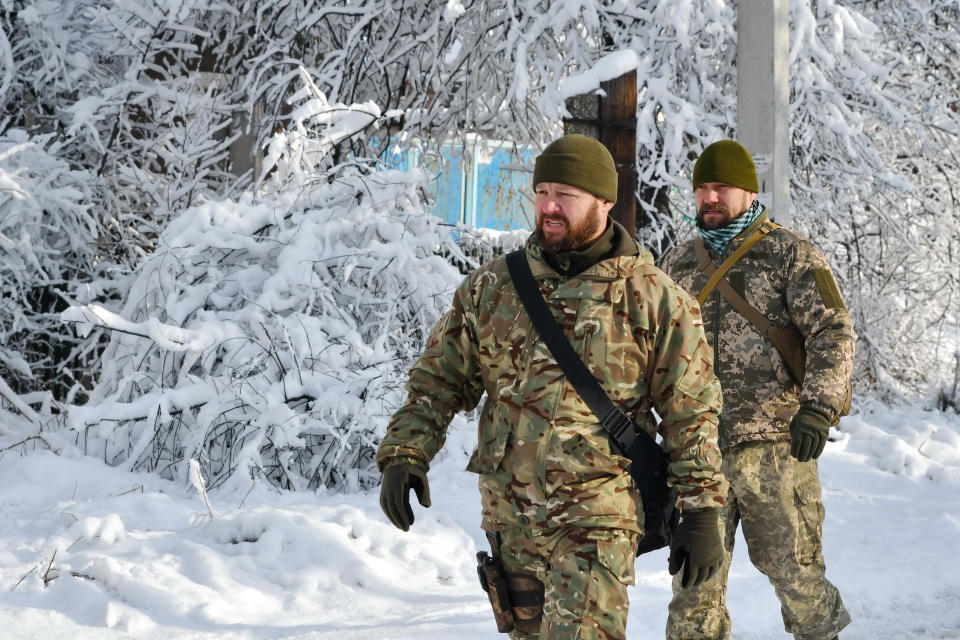 Ukrainian army soldiers are seen walking by the street of the Verkhnotoretske village that is situated on the very frontline between Ukraine and DPR positions. Russian diplomats will take part in talks with the United States in January 2022 on a list of security guarantees Moscow wants from Washington amid simmering tension between the pair over Ukraine. Russia's deputy defense minister in December 2021 warned foreign ambassadors of a 