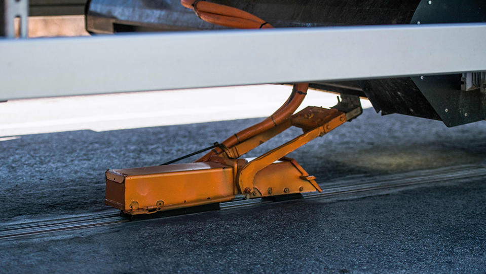 An all-electric truck is attached to the first "eRoad" of its kind, an approximately two-kilometer-long electrified road on April 11, 2018 at Arlanda airport, north of Stockholm. This eRoadArlanda is an example of a sustainable and cost-effective solution to enable the electrification of existing commercial roads. The electrified road, a Swedish innovation, is the first of its kind in the world and allows both commercial and passenger vehicles to be recharged while driving.   / AFP PHOTO / Jonathan NACKSTRAND (Photo credit should read JONATHAN NACKSTRAND/AFP via Getty Images)