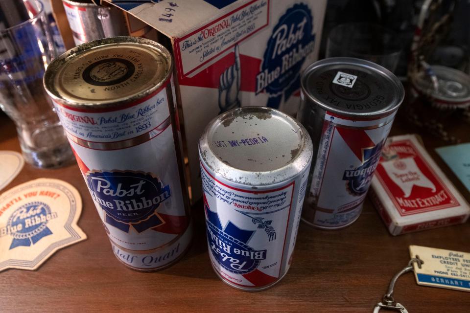 Several cans, including one from the Pabst brewery's last day of operation, are displayed on a shelf inside The 33 Room in Peoria Heights on Dec. 15, 2021.