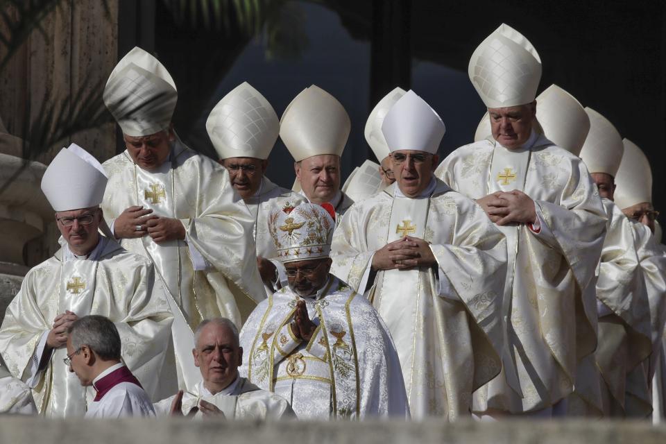 Prelates attend a canonization Mass in St. Peter's Square at the Vatican, Sunday, Oct. 13, 2019. Pope Francis on Sunday canonized Cardinal John Henry Newman, the 19th-century Anglican convert who became an immensely influential, unifying figure in both the Anglican and Catholic churches. Francis presided over Mass on Sunday in a packed St. Peter's Square to declare Newman and four women saints. (AP Photo/Alessandra Tarantino)