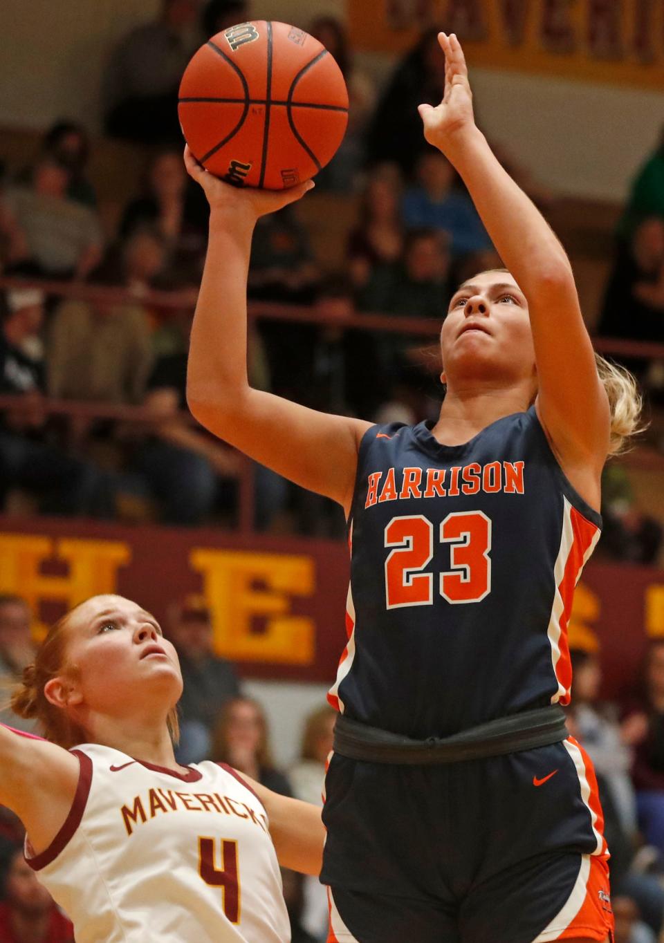 McCutcheon Mavericks forward Marley Dale (4) defends the shot of Harrison Raiders forward Riley Whitlock (23) during the IHSAA girl’s basketball game, Friday, Dec. 15, 2023, at McCutcheon High School in Lafayette, Ind.