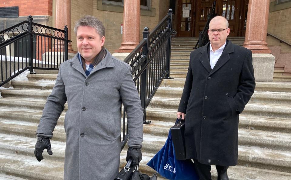 Government lawyers Michael Hynes (left) and John Gillis leave court Thursday, where Hynes told the three-justice panel that the province was looking for a resolution “as soon as is reasonably possible.”