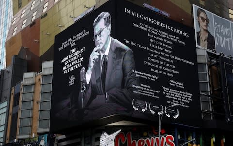 A billboard for late-night talk show host Stephen Colbert is seen near Times Square in the Manhattan borough of New York City - Credit: Reuters