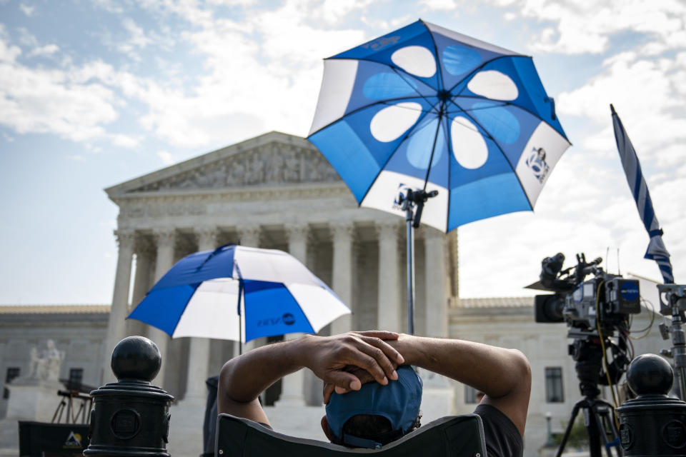 WASHINGTON, DC - JULY 06:  Members of the press work outside of the U.S. Supreme Court on July 6, 2020 in Washington, DC. The Supreme Court issued a unanimous opinion on Monday that says states can require Electoral College voters to back the winner of their states popular vote in a presidential election. The court also upheld a 1991 law that bars robocalls to cellphones. (Photo by Drew Angerer/Getty Images)