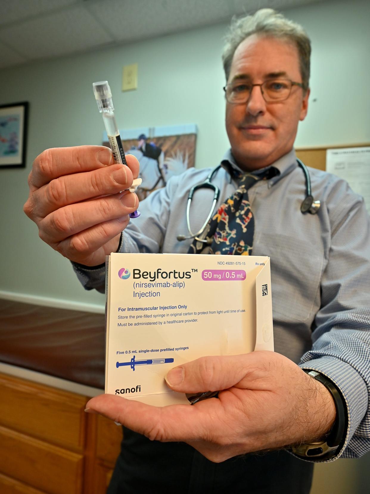 Dr. Ian Harding, owner and medical director at Harding Pediatrics in Worcester, Massachusetts, holds up the last dose he has of a new drug to prevent RSV in infants. The drug was approved in July but supplies have been limited.