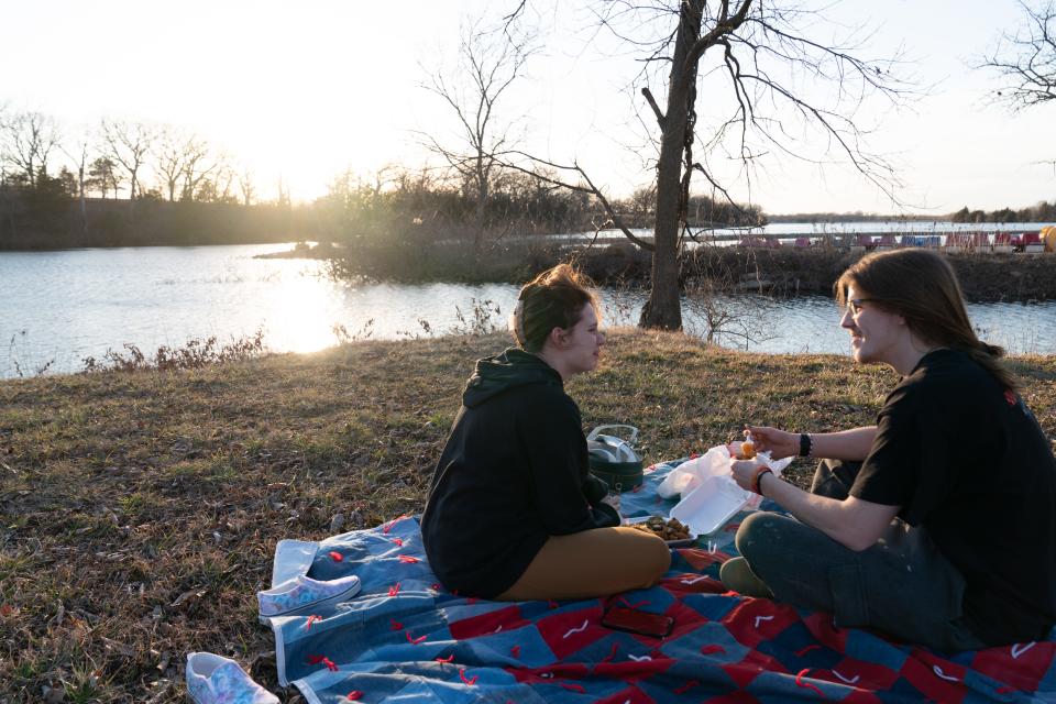 Loki Richins, left, enjoys a picnic date with Colton Gordon on Feb. 14 by the water at Lake Shawnee. Temperatures set a new February record for the warmest average temperature with 60.3 degrees.