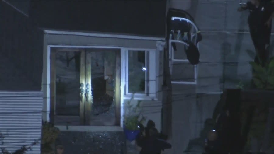 Officers investigating a home invasion in L.A. seen approaching the back of a residence with their guns drawn on July 17, 2024. (Sky5)