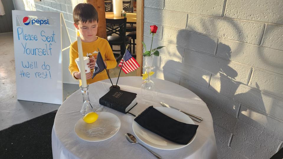 A young boy looks over the Missing Man Table at Nine Line BBQ on Hillside Road in Amarillo.