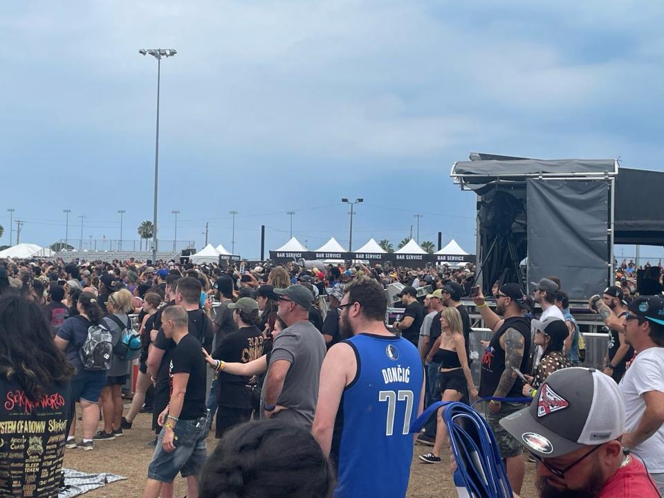 Indianapolis resident Tyler Saunders wears a Luka Doncic jersey amidst the fans during P.O.D.’s set on Sunday. Saunders and other sports fans have found keeping up with the NBA and NHL this weekend to be very difficult.