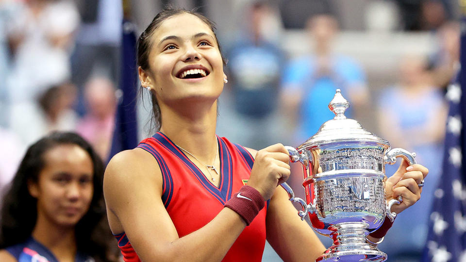 Emma Raducanu is seen here holding the US Open trophy aloft.