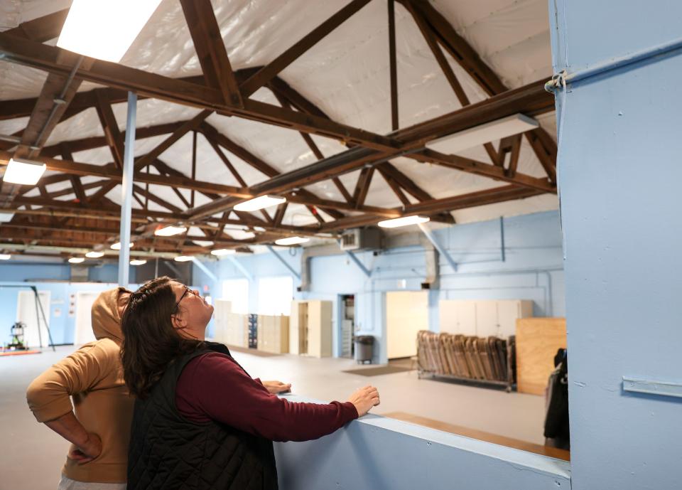 Gervais School District facilities employee Julie Powers looks at the ceiling of Gervais Elementary School where water was leaking on March 28. The proposed bond would fund renovations like roof and window replacements.